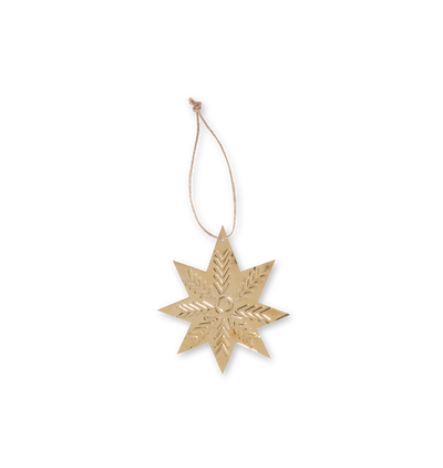 A star shaped tin ornament with embossed details on a twine string set against a white background
