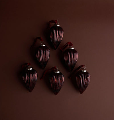 An arrangement of ribbed brown glass ornaments on a cocoa background