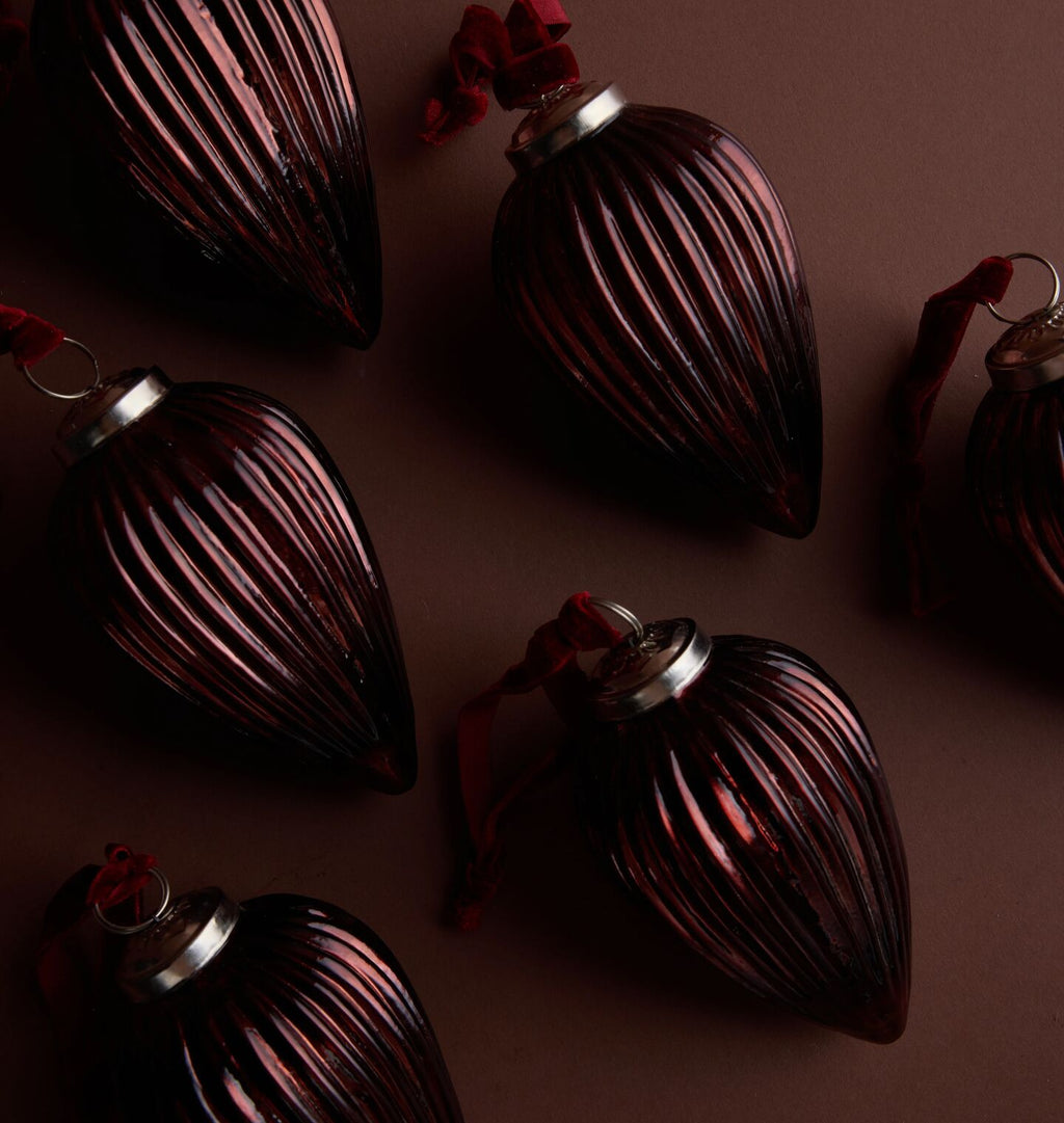 A close up detail shot of brown ornaments arranged on a light brown background