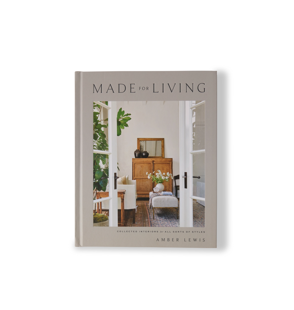 A hardcover book titled 'Made for Living' by Amber Lewis, featuring a warm-toned interior photograph on the cover, set against a clean off-white background.
