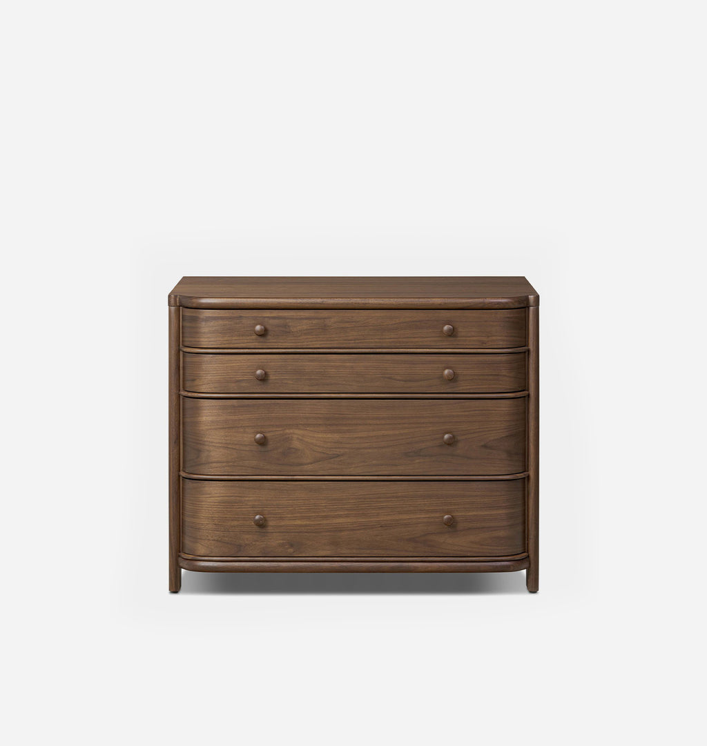 A four-drawer wooden chest of drawers with a curved front and small round knobs, shown against a plain light gray background.