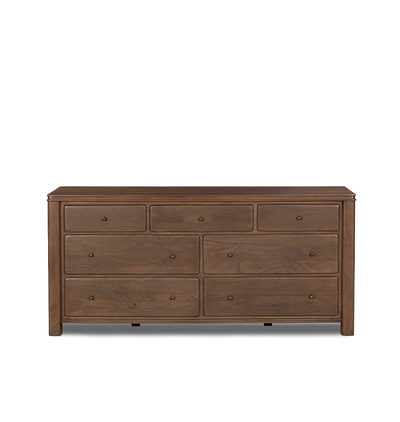 A seven-drawer wooden chest of drawers with small round brass knobs, shown against a plain light gray background.