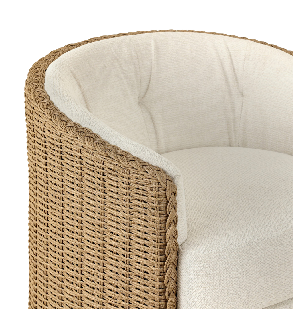 A curved outdoor swivel chair with a woven braided wicker back and sides and plush off white tufted seating