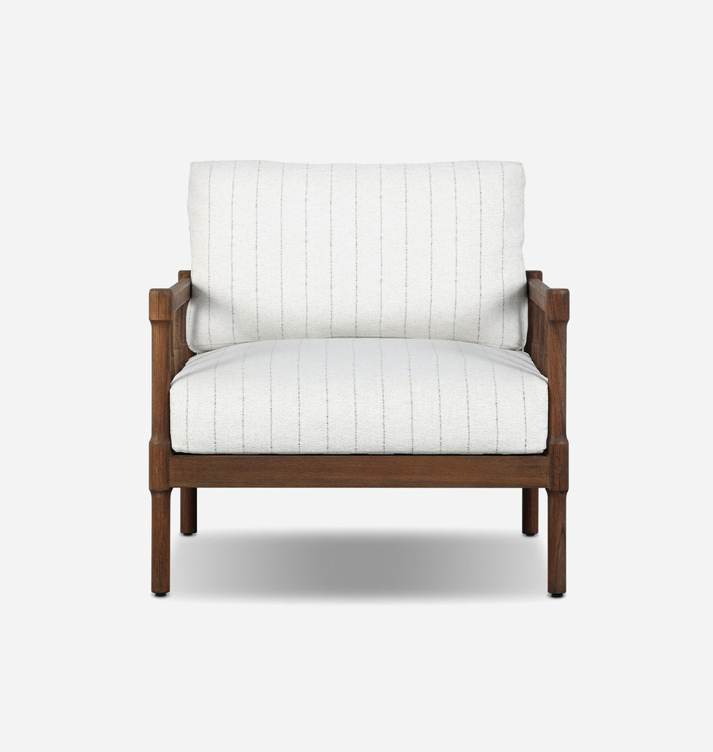 A modern outdoor accent chair featuring a warm brown wooden frame and off-white striped fabric upholstery, shown against a plain light gray background.