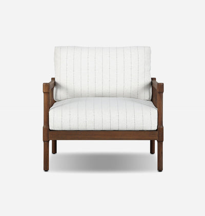 A modern outdoor accent chair featuring a warm brown wooden frame and off-white striped fabric upholstery, shown against a plain light gray background.