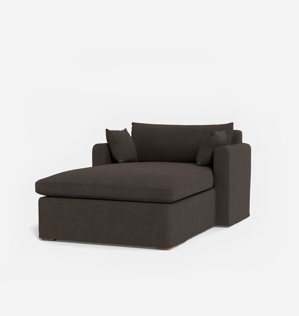 A modern gray brown chaise lounge chair with two matching throw pillows, shown on a clean white background.