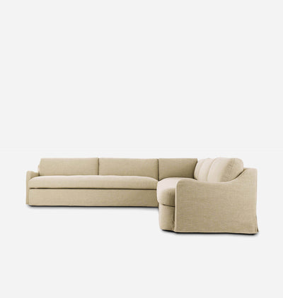 A modern L-shaped sectional sofa upholstered in a light beige textured fabric, shown from a three-quarters angle against a solid white background.