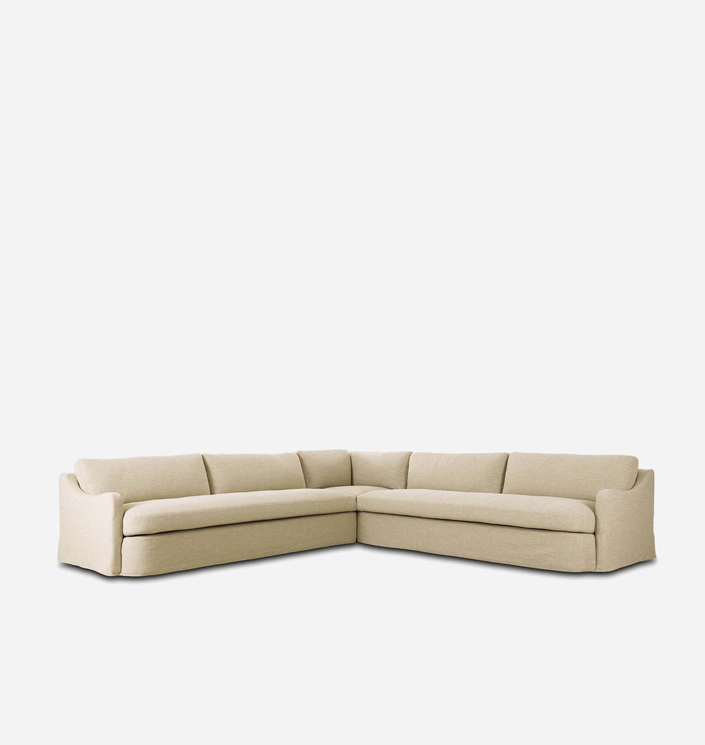 A modern L-shaped sectional sofa upholstered in a light beige textured fabric, shown from a three-quarters angle against a solid white background.