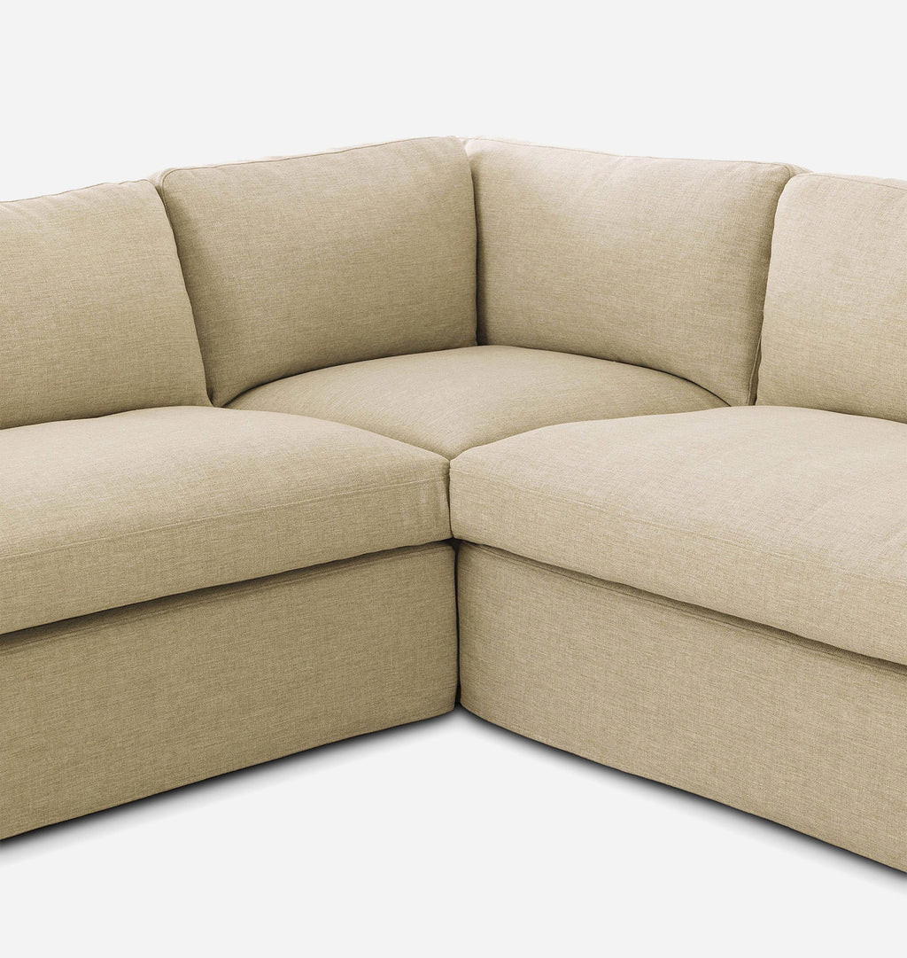 Beige fabric corner sectional sofa with plush seat and back cushions, photographed on a clean white background.