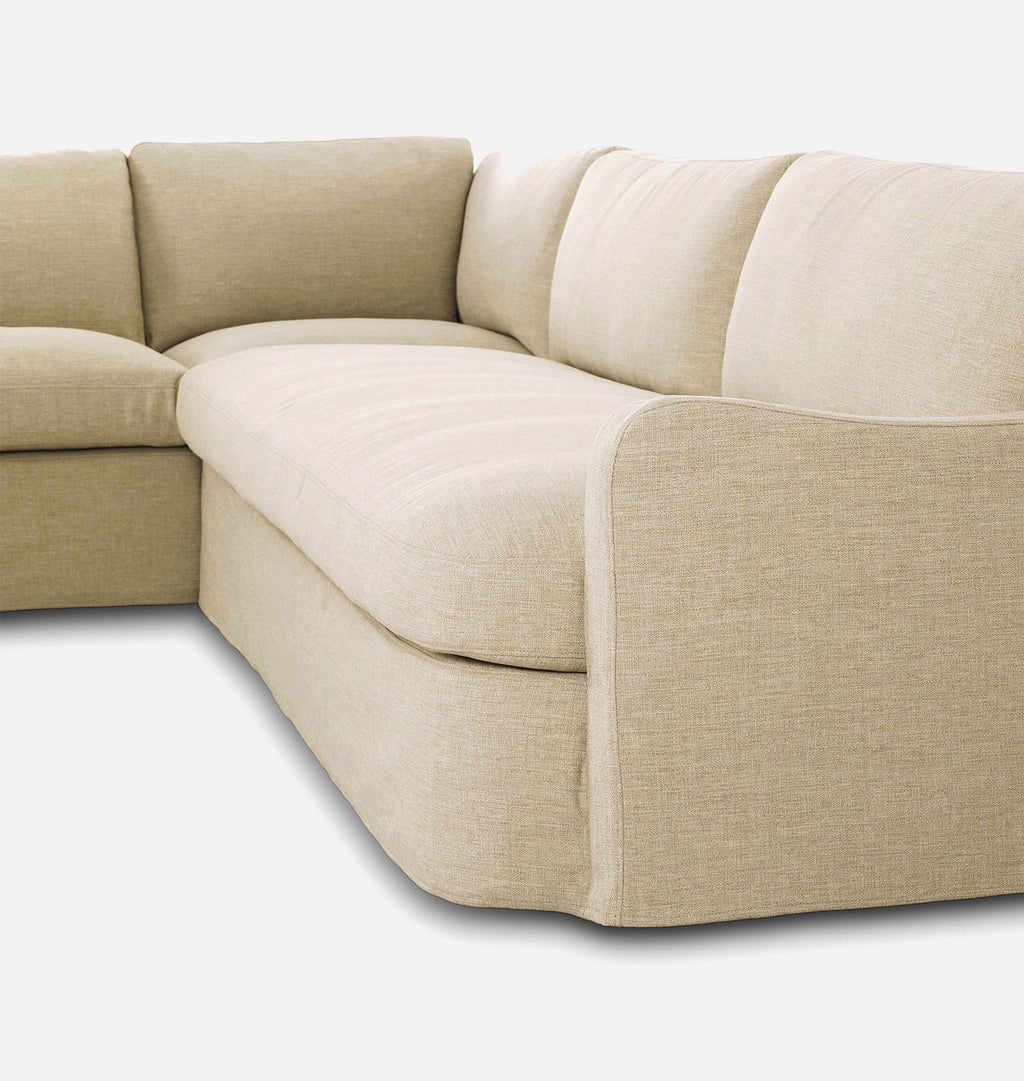 Beige upholstered sectional sofa corner section with plush seat and back cushions, shown on a clean white background.