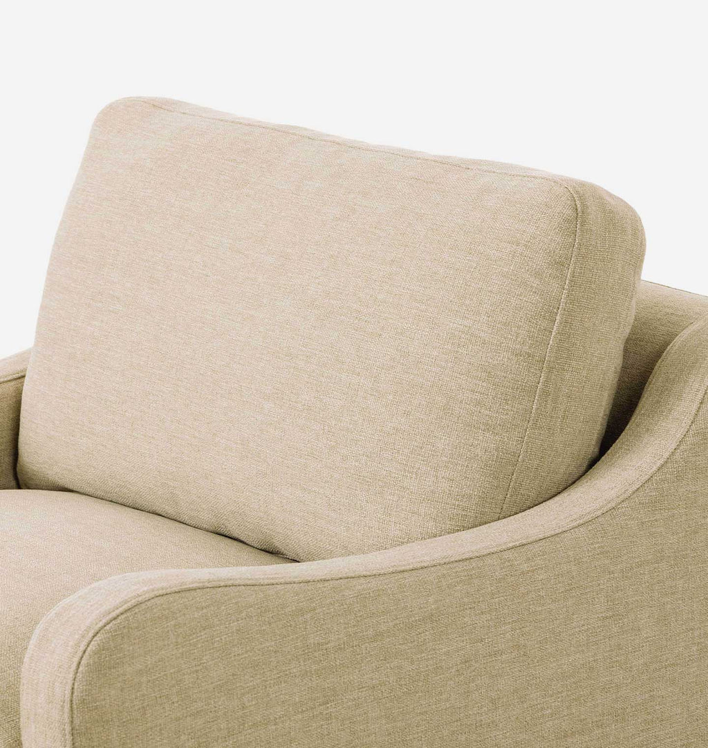 Close-up of a beige upholstered armchair showing the back cushion, armrest, and textured fabric against a plain light background.