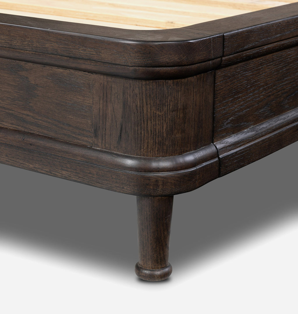 Close-up of a dark brown wooden furniture piece, showing the corner joint, turned leg, and light natural wood top surface.