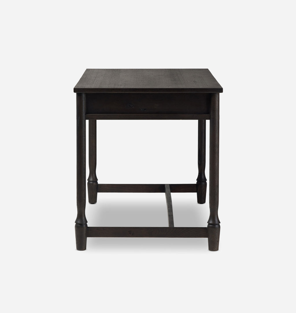 A dark brown wooden side table with a single drawer, turned legs, and a lower support rail, shown against a light gray background.