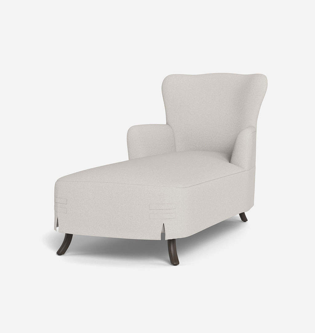 A modern wingback chaise lounge chair upholstered in a light beige textured fabric, featuring dark brown wooden legs, shown against a plain white background.