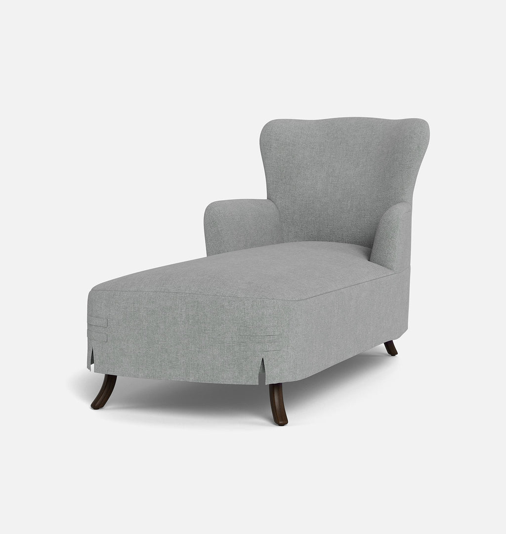 A light gray upholstered wingback chaise lounge chair with dark wooden legs, shown from a three-quarter angle on a clean white background.