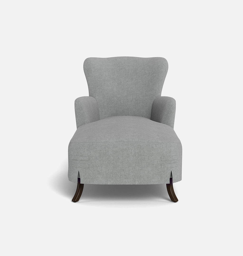 A light gray upholstered chaise armchair with a high wingback backrest and dark wooden legs, shown against a plain light gray background.