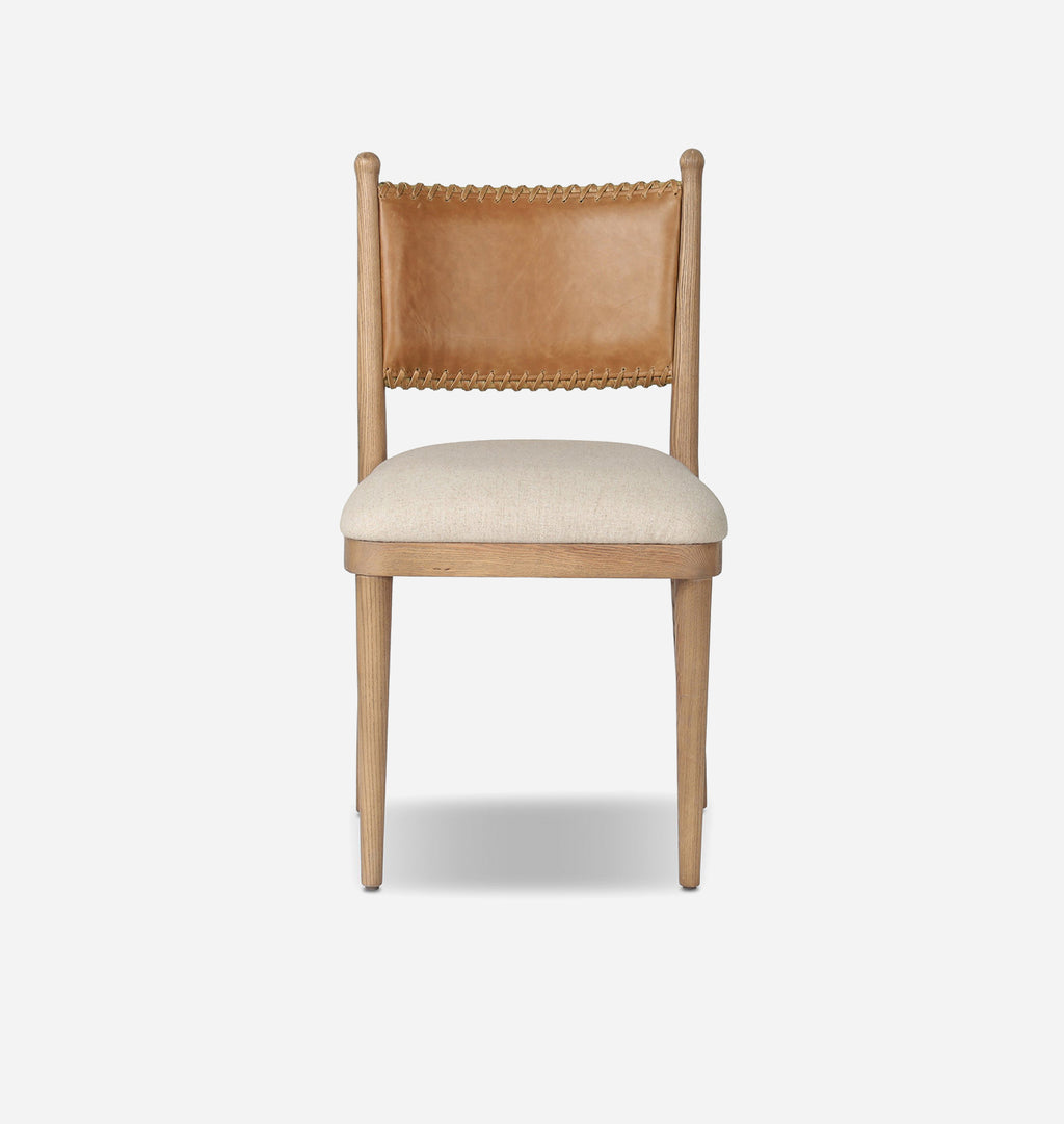 A modern dining chair featuring a light natural wood frame, a tan leather backrest with nailhead trim, and a light beige upholstered seat, shown against a plain light gray background.