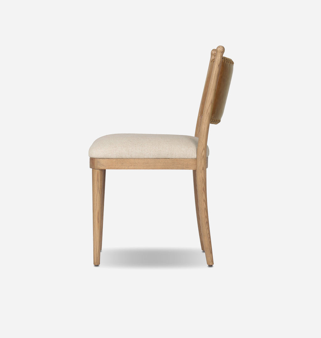 A light oak wood dining chair with a cream-colored upholstered seat cushion, shown from a side profile view against a plain white background.