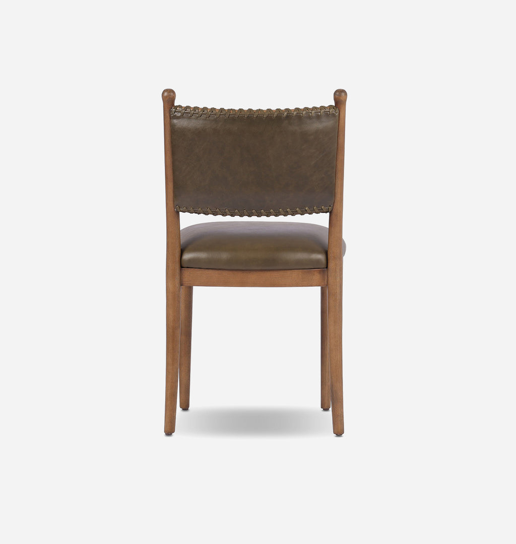 A wooden dining chair with a brown leather upholstered seat and backrest, featuring a decorative nailhead trim along the top of the backrest, shown against a plain light gray background.