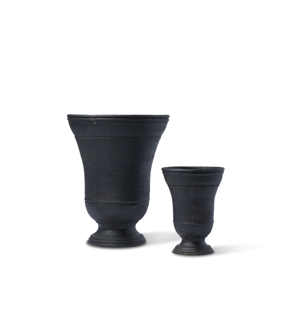Two black urn shaped vases on a white background