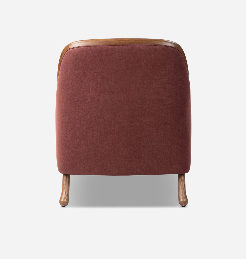 A modern accent chair with a square back upholstered in rust-red fabric, featuring a curved wooden top frame and tapered wooden legs, shown against a light gray background.
