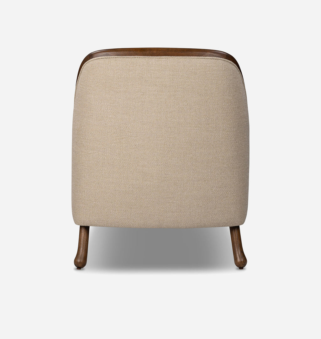 A modern accent chair with a beige textured fabric upholstery, dark brown wooden legs, and a curved dark brown wooden top frame, shown from the back against a light gray background.