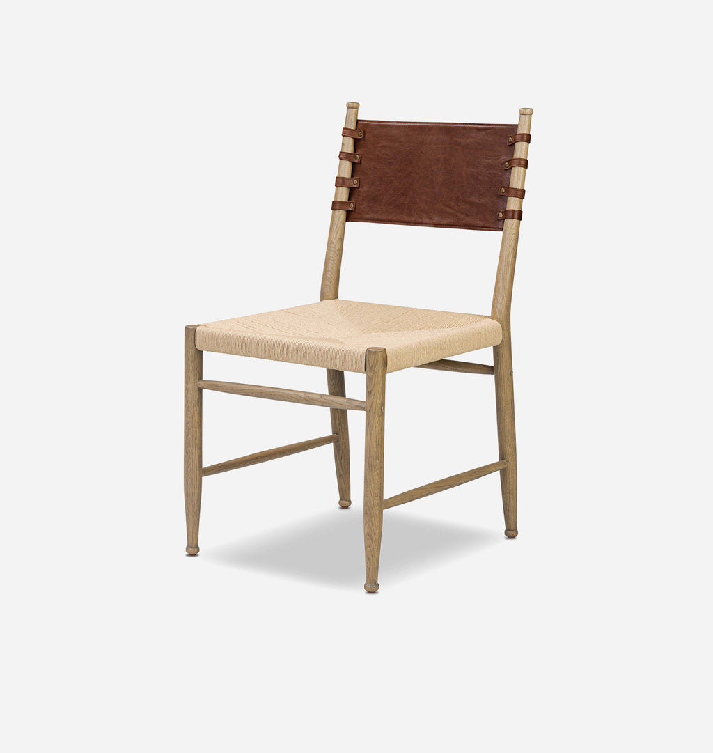 A mid-century modern wooden dining chair with a light natural wood frame, a beige woven seat, and a brown leather backrest, shown on a light gray background.