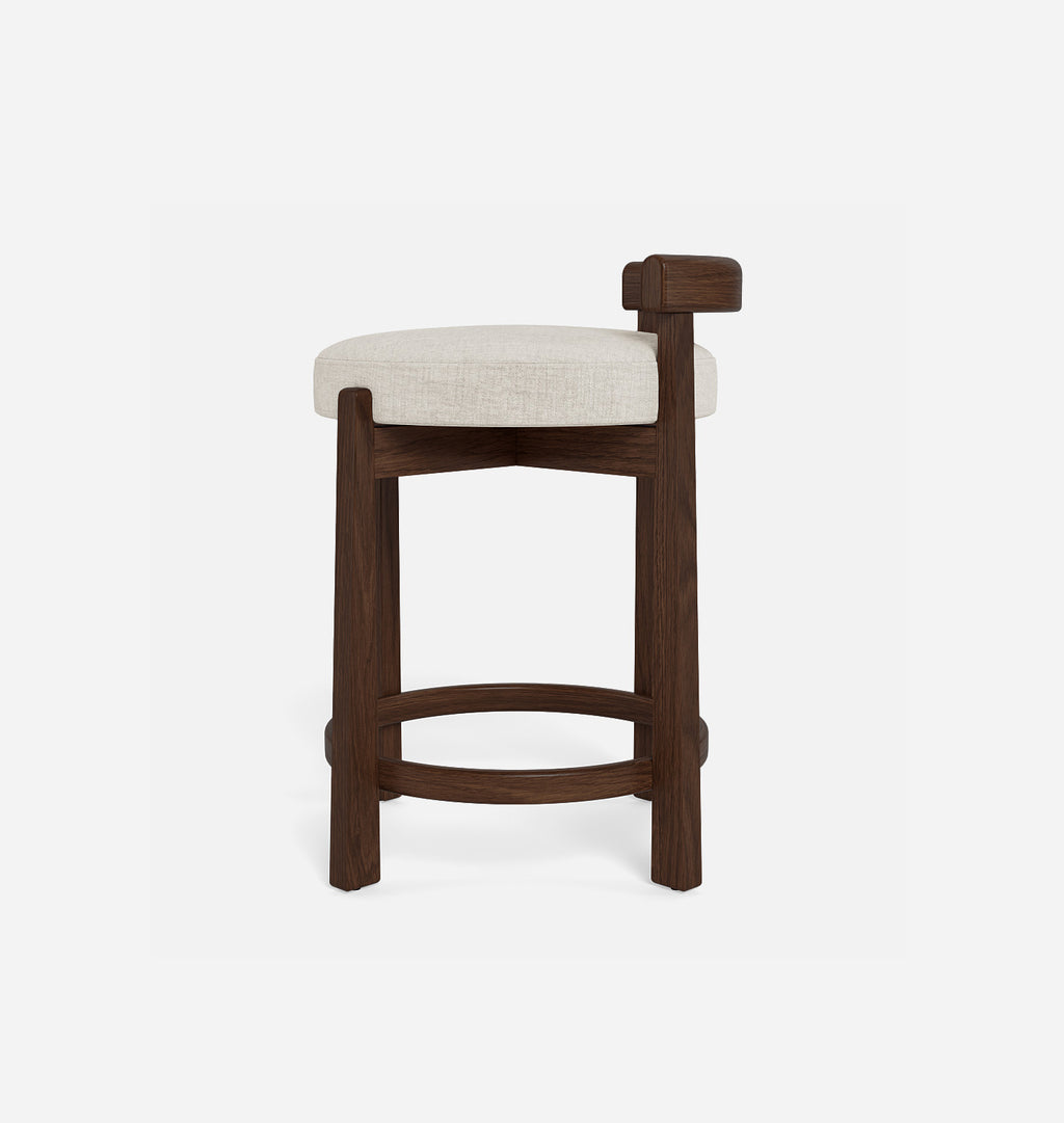 A modern bar stool with a dark brown wooden frame, a curved footrest, and a round off-white upholstered seat cushion, shown against a plain light gray background.