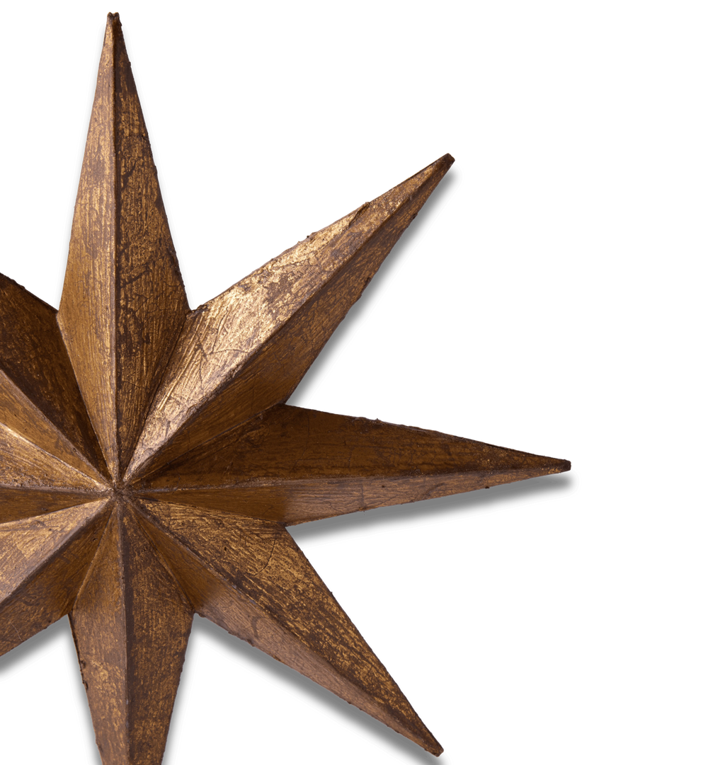 A close-up of a rustic, metallic bronze star ornament on a solid white background.
