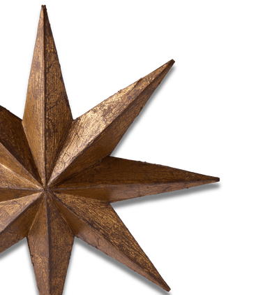 A close-up of a rustic, metallic bronze star ornament on a solid white background.