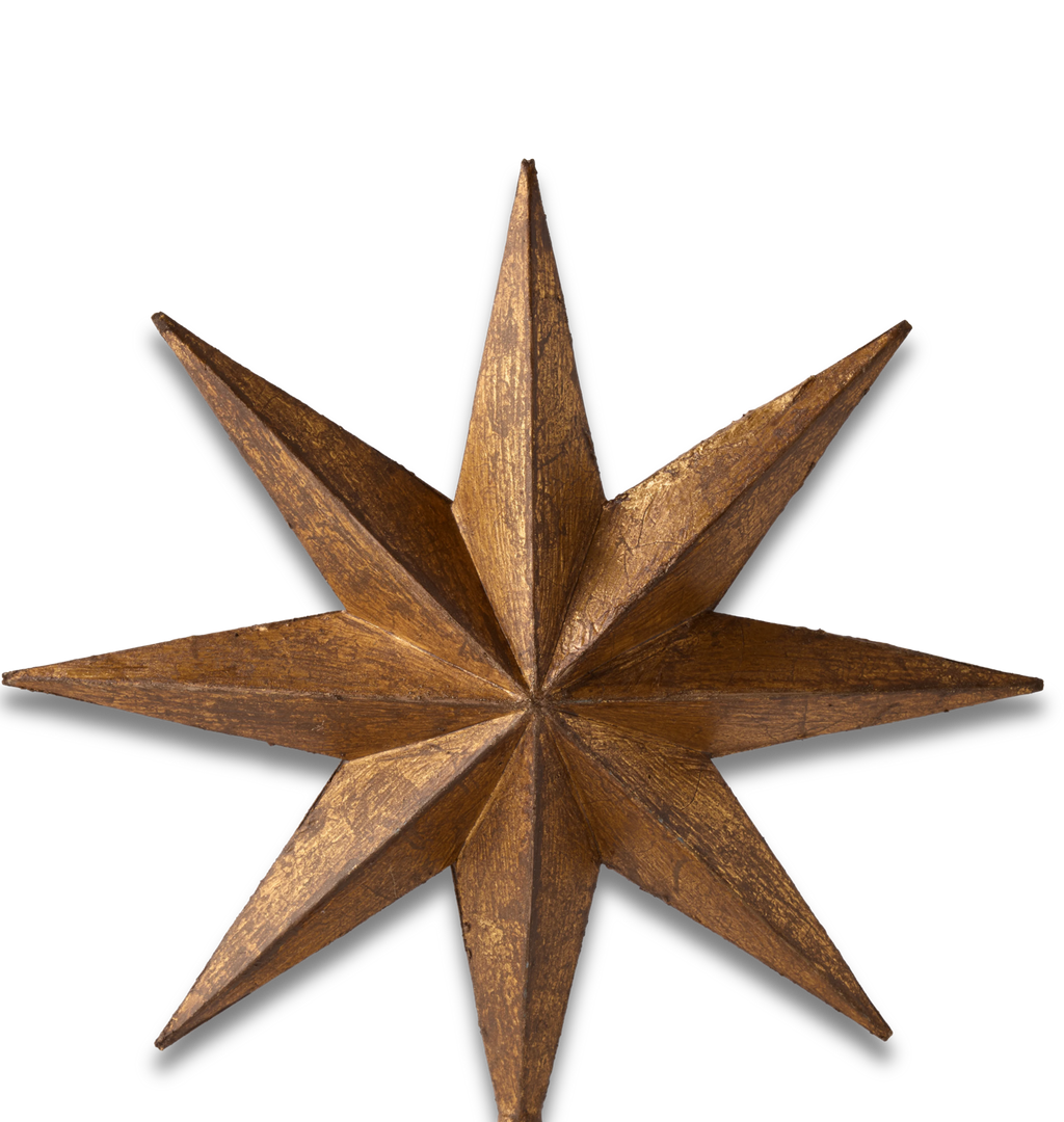 A close-up of a rustic, metallic bronze star ornament on a solid white background.