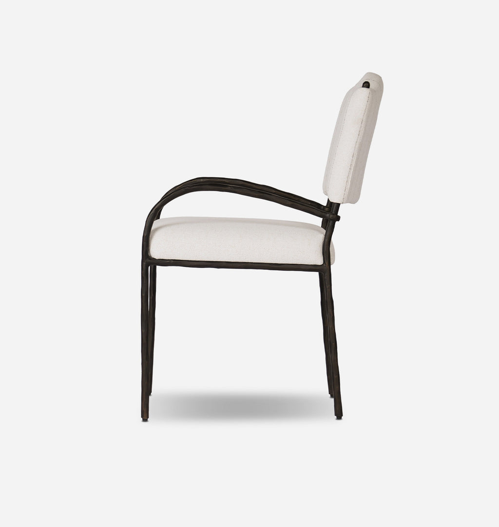 A modern outdoor dining chair with a dark metal frame and light beige upholstered seat and backrest, shown from a side profile on a light gray background.