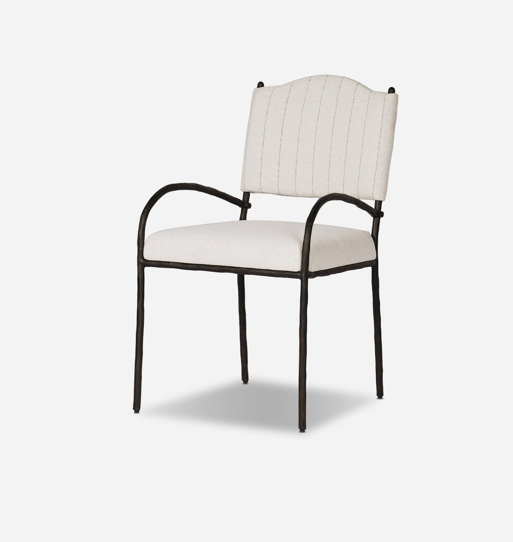 An outdoor dining chair with a cream-colored fabric seat and backrest featuring vertical stripe pattern, supported by a dark bronze metal frame with curved armrests.