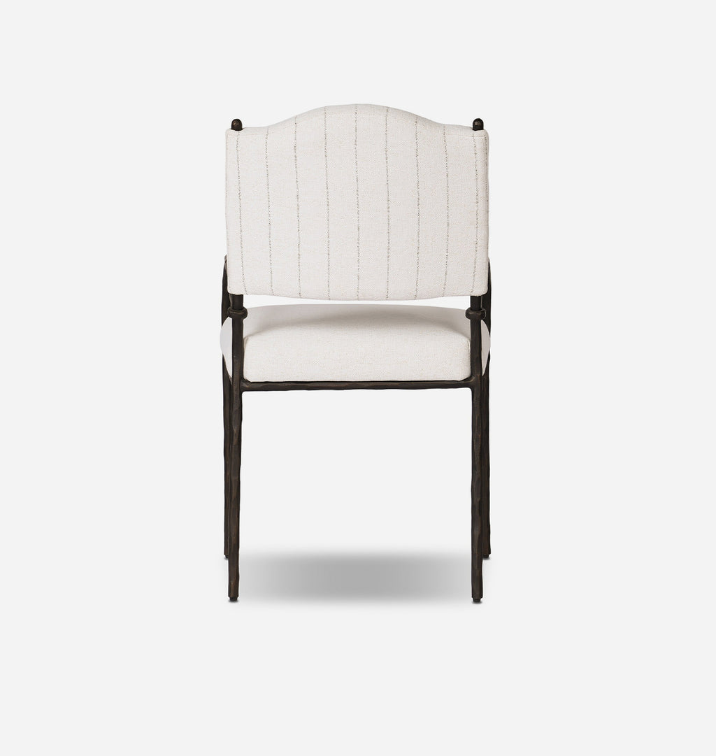 An outdoor dining chair with a cream-colored fabric seat and backrest featuring stripe pattern, supported by a dark bronze metal frame with curved armrests.