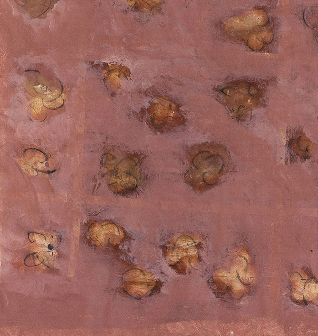 A close-up of a textured terracotta or rust-colored surface with scattered irregular patches of tan, brown, and muted gold, resembling a painted or printed abstract pattern.