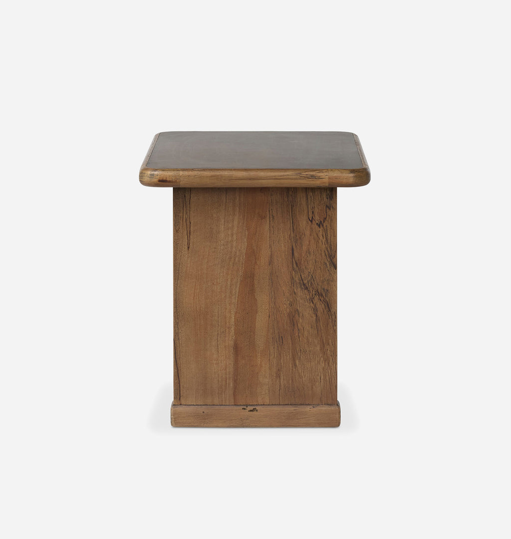 A rustic wooden side table with a square top and a thick pedestal base, shown against a plain light gray background.