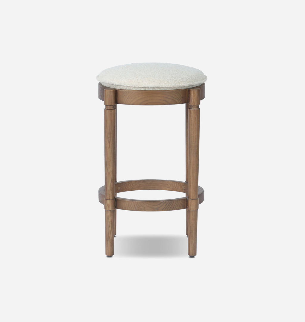 A wooden bar stool with a round off-white textured seat cushion and a medium brown wood frame, shown against a plain light gray background.