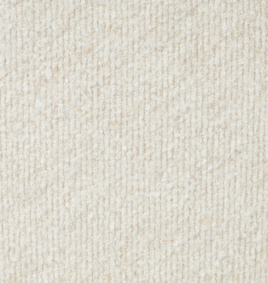 A close-up texture shot of a warm off-white or cream woven fabric, showing a fine ribbed pattern.