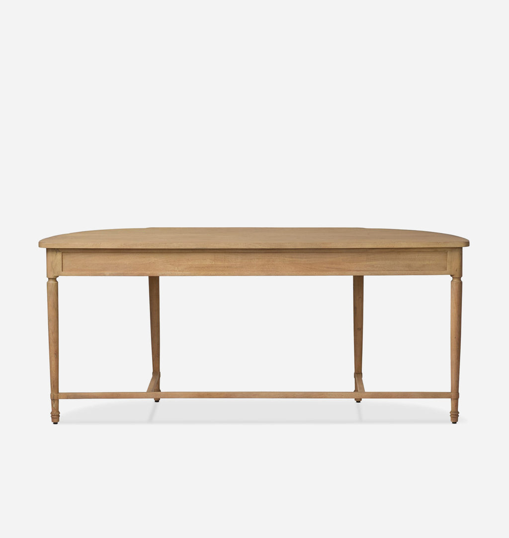 A light natural wood dining table with a rounded rectangular top, turned legs, and a front stretcher bar, shown against a plain light gray background.