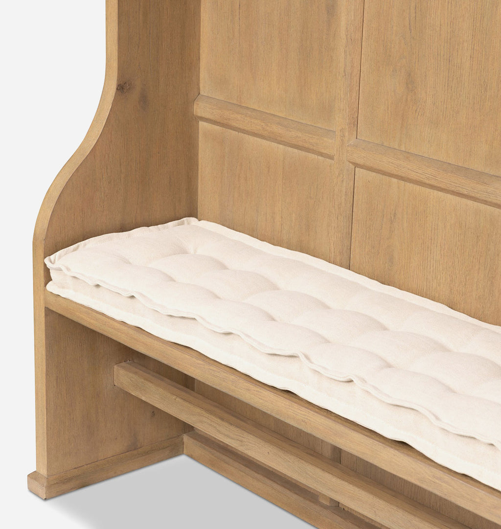 A close-up of a light oak wooden bench with a padded cream-colored cushion on the seat, set against a white background.