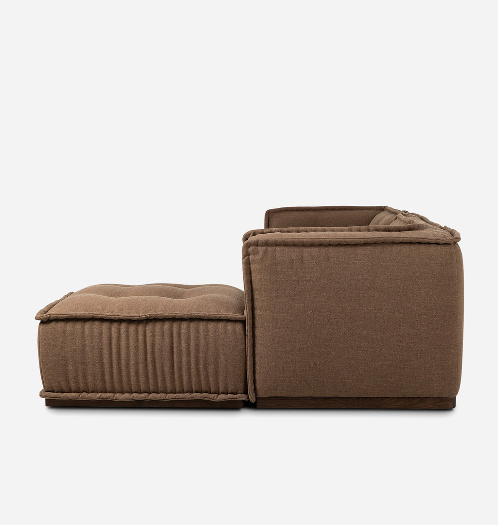 An upholstered seating set consisting of a square ottoman with vertical channel tufting and a matching seat, both in a warm taupe-brown fabric, shown against a plain light gray background.