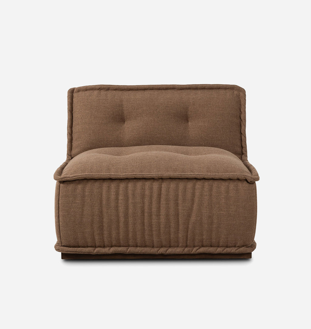 A brown upholstered floor cushion or small chair with a tufted backrest and ribbed sides, shown against a plain light gray background.
