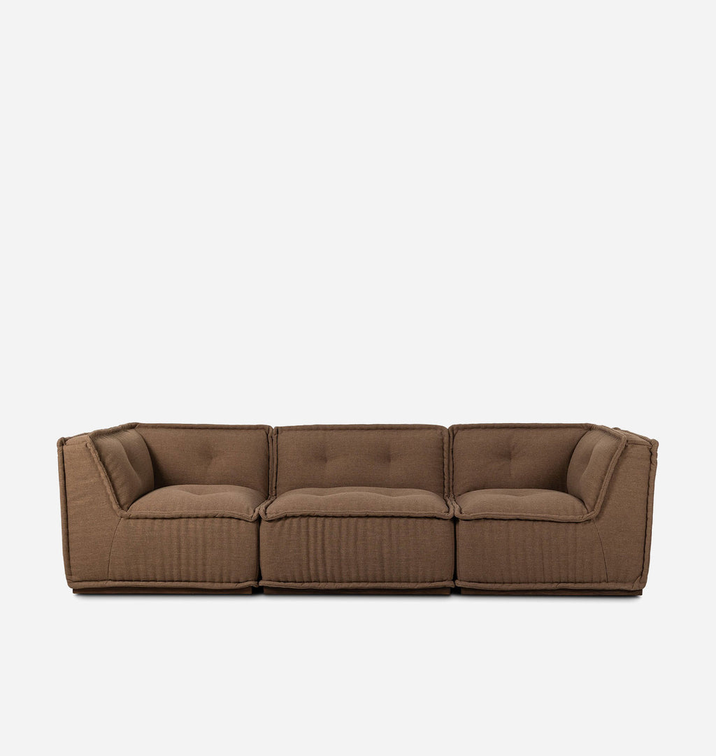 A three-seater modular sofa upholstered in a textured brown fabric, featuring tufted back cushions and a ribbed front panel, shown against a plain white background.