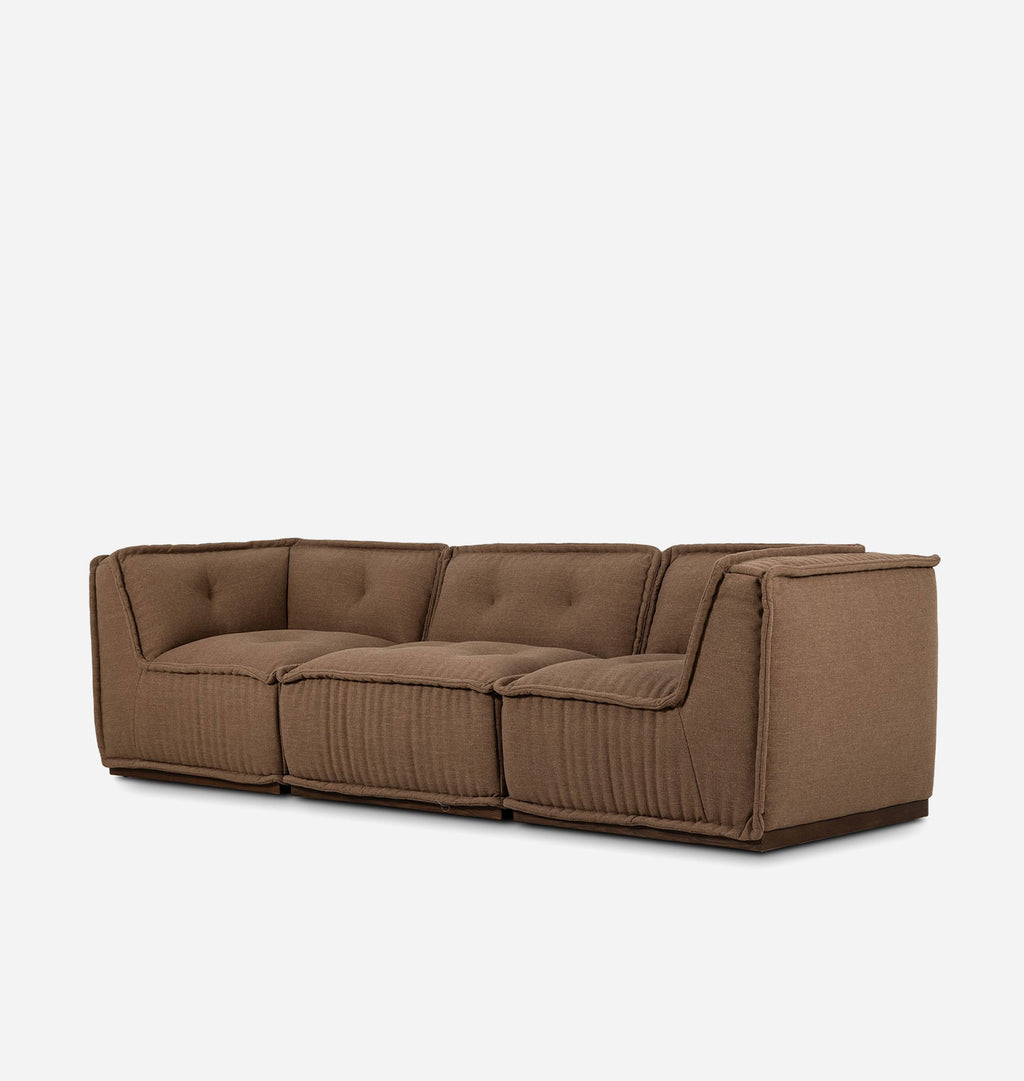 A modern three-seater sofa upholstered in a textured brown fabric with tufted back cushions and ribbed front panels, shown against a plain light gray background.