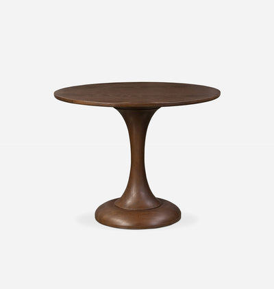 A round wooden pedestal table with a medium-to-dark brown finish, featuring a flared circular base, shown against a plain light gray background.