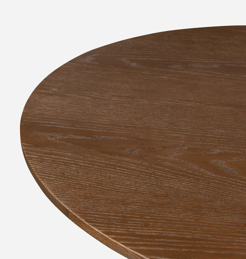 Close-up of a round wooden table top with a medium brown wood grain finish, shown against a plain white background.
