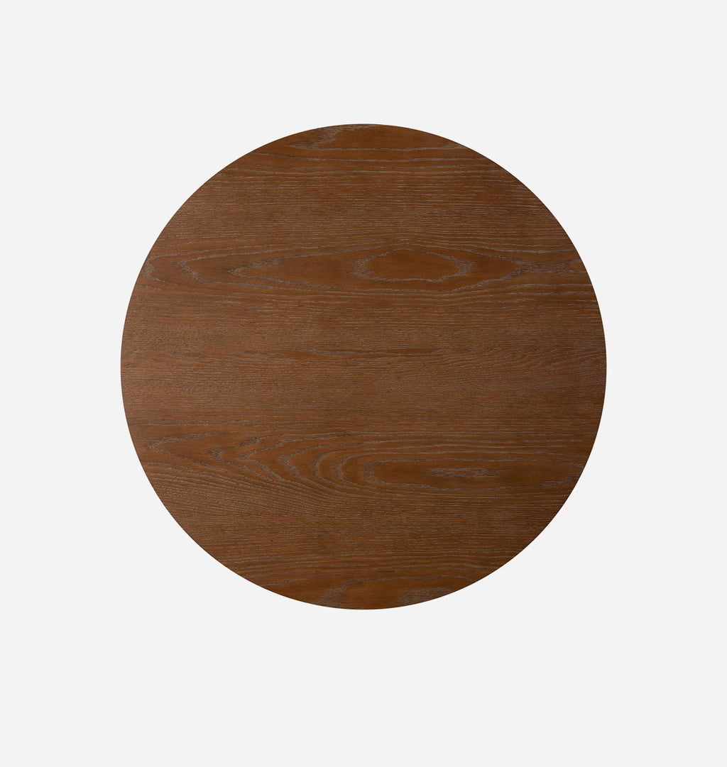 A round wooden tabletop with a medium brown finish and visible wood grain, shown from a top-down view on a light gray background.