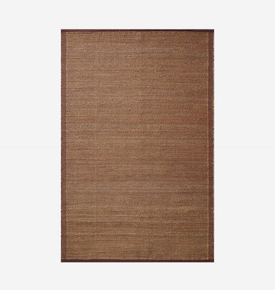 A rectangular woven area rug in a warm medium brown color, featuring a subtle textured weave and a darker brown border, shown flat against a light gray background.