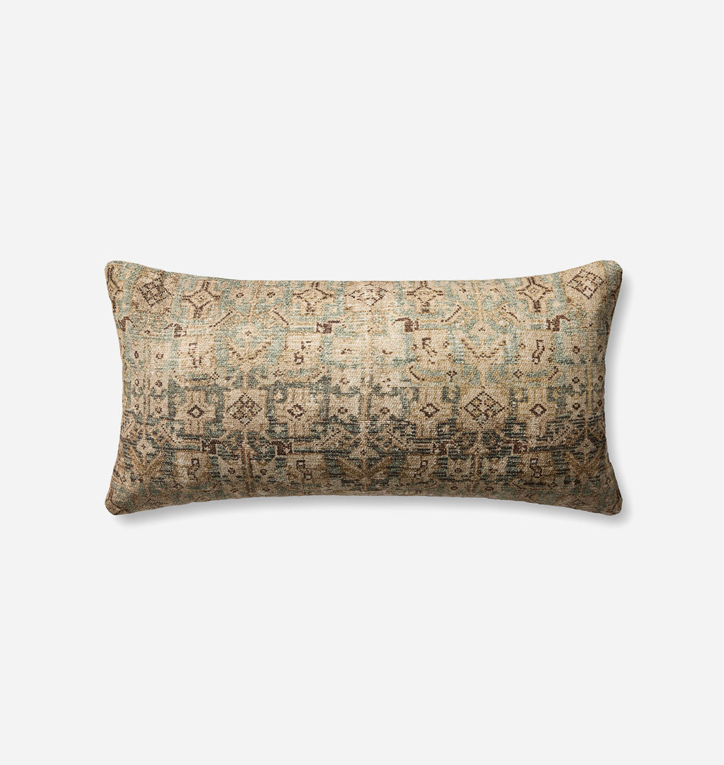 A rectangular lumbar throw pillow with a distressed, vintage-style geometric pattern in muted beige, teal, and brown tones, shown against a plain light gray background.