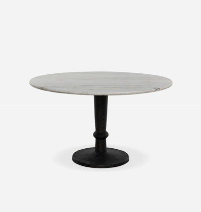A round dining table with a light gray marble top and a black cast iron pedestal base, shown against a plain white background.